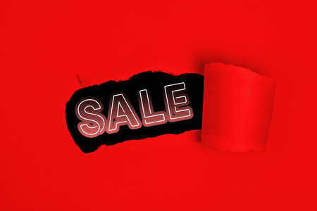 Red torn paper whole with sale text promoの写真素材
