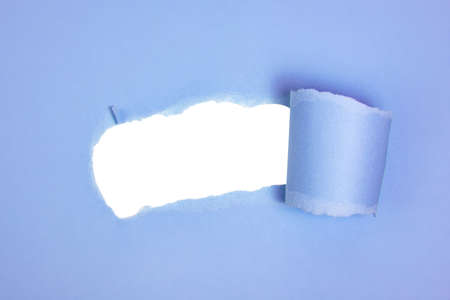 Blue torn paper whole with copyspaceの写真素材
