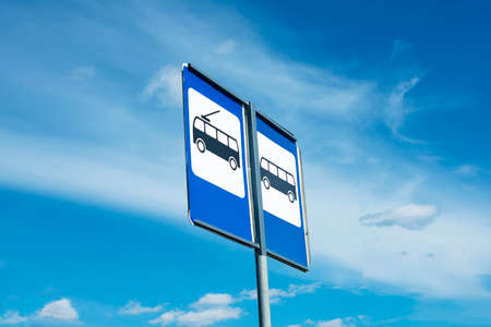 The bus stop sign on blue background on the beautiful skyの写真素材