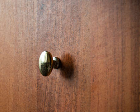 Door metalic knob on brown wooden backgroundの写真素材