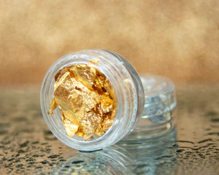 Bright foil design for nails manicure no people on wet creative background selective focusの写真素材