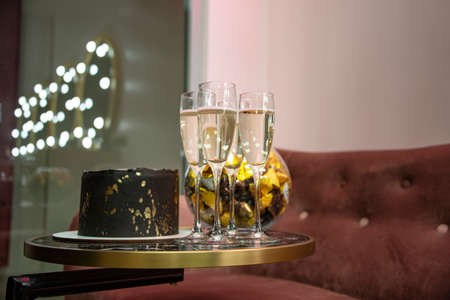 On table champagne glass beauty neon board on background. Selective focus and no trademark.の写真素材