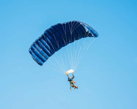 Skydiver activity sport jump on the blue sky backgroundの写真素材