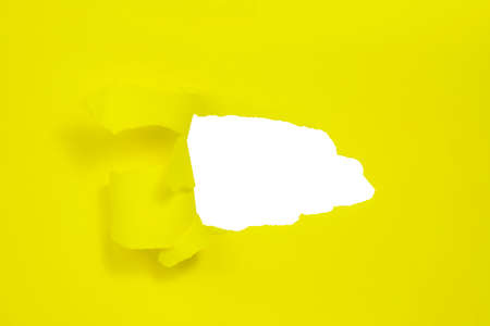 Yellow paper with hole isolated background with copy space