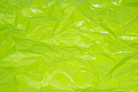 Crumpled green paper bright texture background