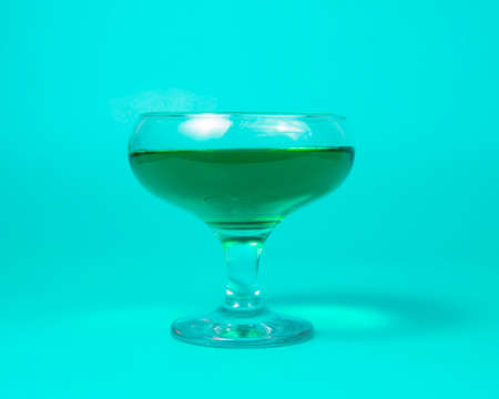 Green liqueur cocktail on color background with copy spaceの写真素材