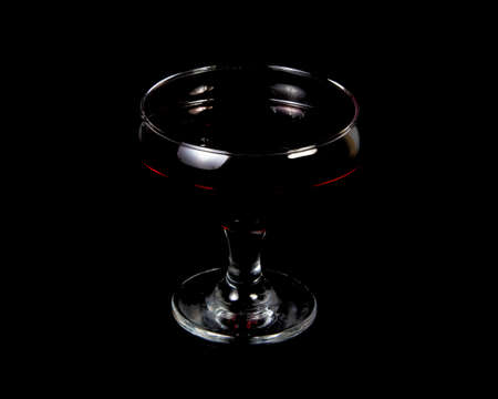Red wine in glass on black background with copy spaceの写真素材
