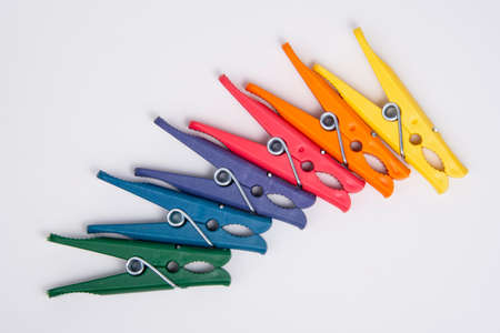 Clothes pegs or pin multicolor for house isolated on the white background