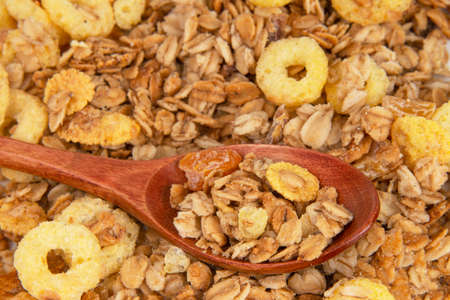Oatmeal cereal breakfast in wooden spoon textured backgroundの写真素材