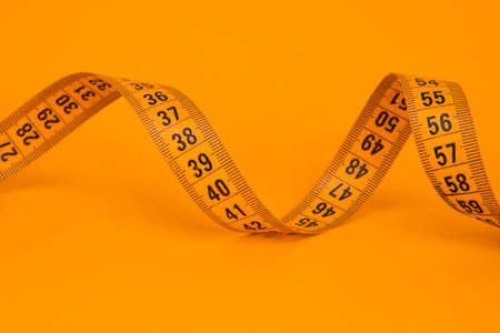 Spiral tape measure colorful background with copyspace
