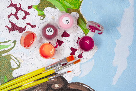 painting by numbers. Set to paint the picture, includes a canvas, paints of different colors, brushes. top view.の写真素材