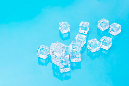 Ice cubes on blue background, Cubes of ice on a light blue background, Flat lay, top view