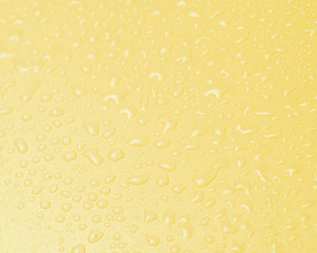 Yellow water drops background texture macro photoの写真素材