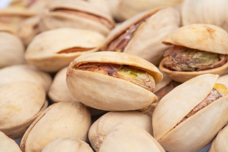 Pile of pistachio nuts close up. Background of salted pistachiosの写真素材