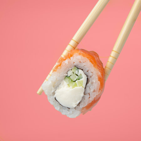 Sushi roll with chopsticks isolated on white
