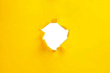 Yellow torn paper isolated on white background, copy spaceの写真素材