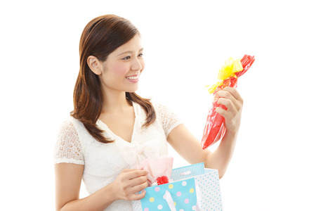Woman smiling with a giftの写真素材