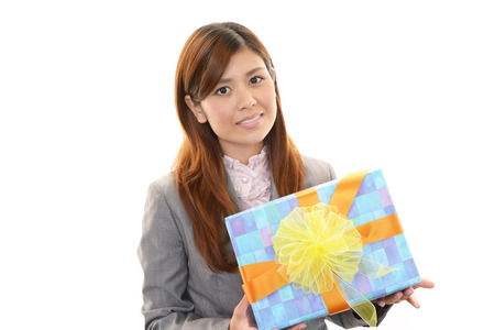 Woman smiling with a giftの写真素材