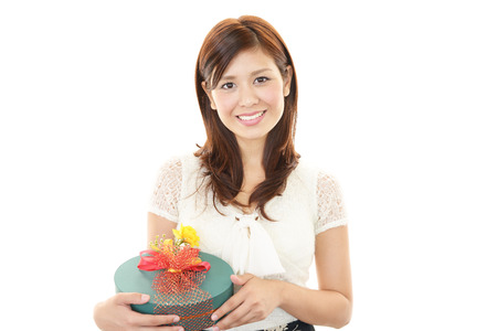 Woman smiling with a giftの写真素材