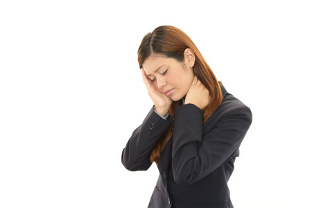 Business woman with shoulder painの写真素材
