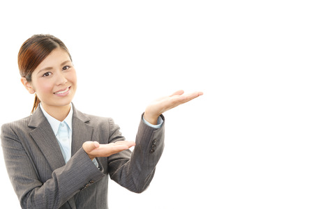 A woman showing something on the palm of her handの写真素材