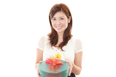 Smiling woman with a giftの写真素材