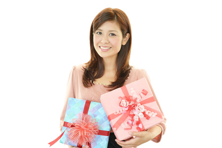 Smiling woman with a giftの写真素材
