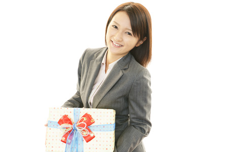 Smiling woman with a giftの写真素材