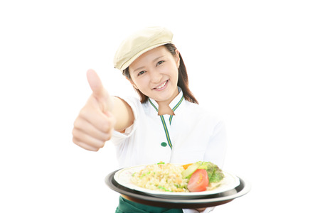 Waitress delivering meal to tableの写真素材