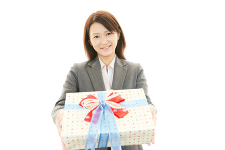 Smiling woman with a giftの写真素材