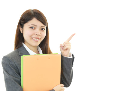 Business woman showing something on the palm of her handの写真素材