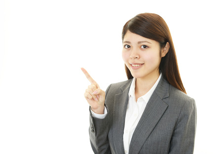 Business woman showing something on the palm of her handの写真素材