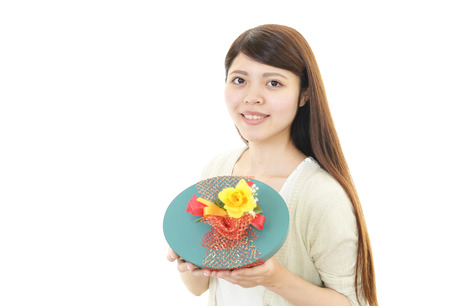 The woman who smiles with a presentの写真素材