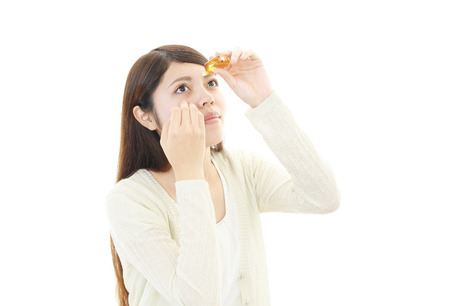A woman who put in the eye dropsの写真素材
