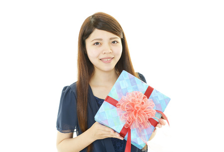 Smiling woman with a giftの写真素材