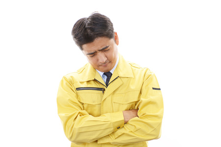 Tired and stressed Asian worker の写真素材