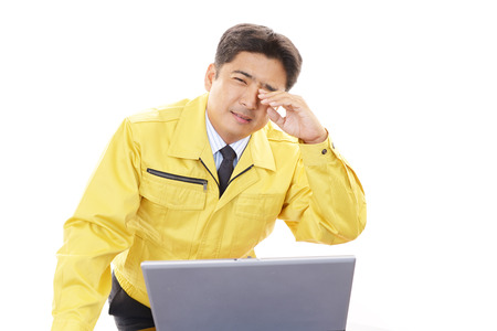Tired and stressed Asian worker の写真素材