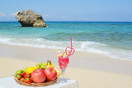 Fresh fruits and beautiful beachの写真素材