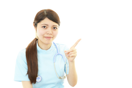 Young female nurse pointingの写真素材