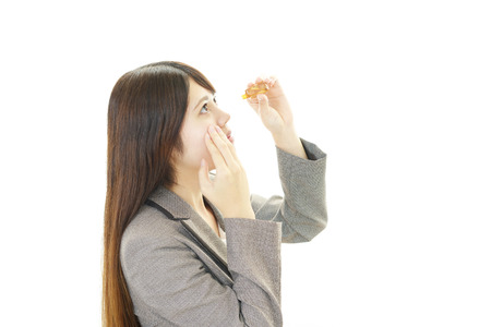 Woman with an eyestrainの写真素材