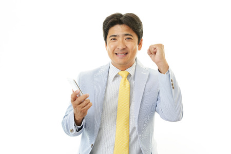 Happy man holding smart phone の写真素材