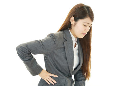Business woman with low back painの写真素材
