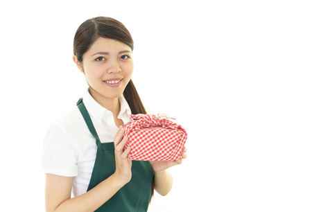 Woman holding a lunch box の写真素材