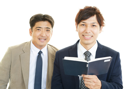 The male office workers who poses happilyの写真素材