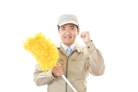 The male worker who poses happily on white background