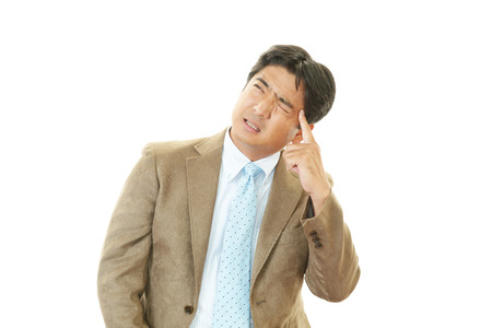 Businessman having a headacheの写真素材