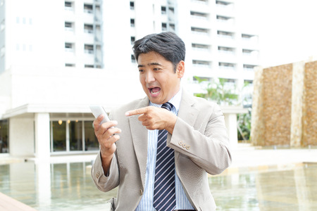 Surprised Asian businessmanの写真素材