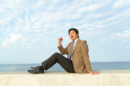 Man sleeping on the breakwaterの写真素材