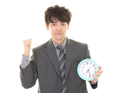 The male office worker who poses happilyの写真素材