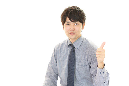 Asian business man showing thumbs up signの写真素材